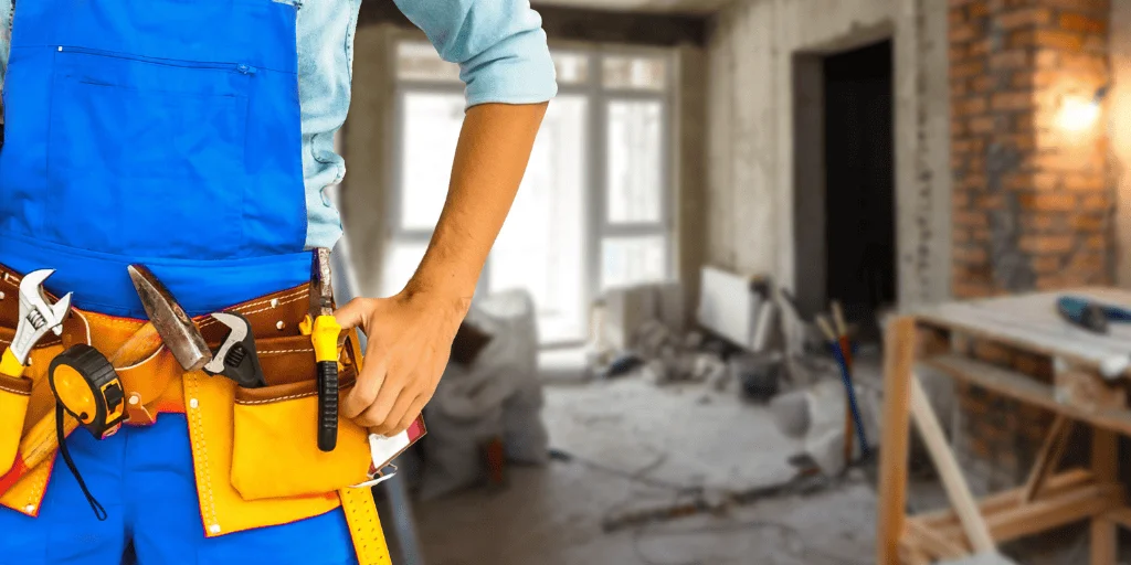 Atlanta handyman services crew member is standing with his tools around his waist.